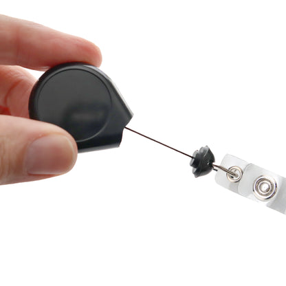 A hand pulls the retractable cord of the Premium No Twist Badge Reel with Swivel Spring Clip – Teardrop Shape (609-I-BLK), a black reel featuring a no twist design and clip at the end.