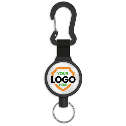 A Customizable Key-Bak 6C Carabiner Badge Reel - Retractable Keychain Reel with 36" Cord and Easy Logo Upload with a carabiner clip at the top and a key ring at the bottom. The central circular area displays a custom logo placeholder with the text "YOUR LOGO HERE." Perfect for promoting brand awareness, this retractable holder is both functional and personalized.