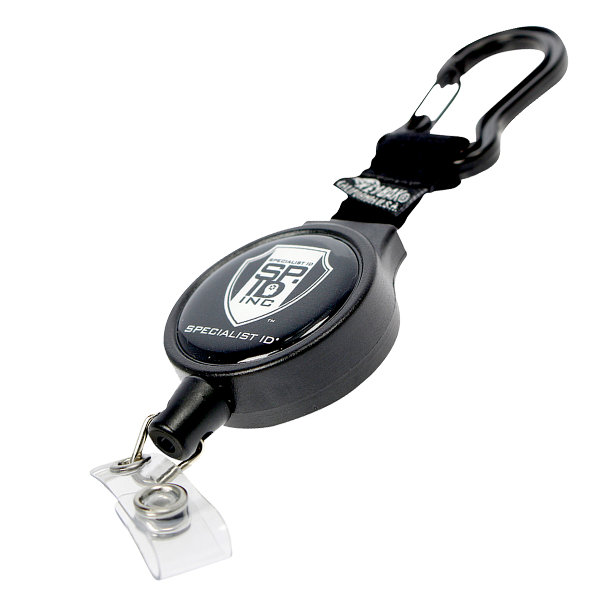 A retractable badge holder with a carabiner clip, featuring a black circular casing with a shield logo and the text "Specialist ID Inc." Personalize your badge reel with this Customizable Carabiner Badge Reel Retractable Badge Holder with Vinyl Strap Clip (6CID) - Add Your Logo. A plastic clip is attached to the end for holding badges.