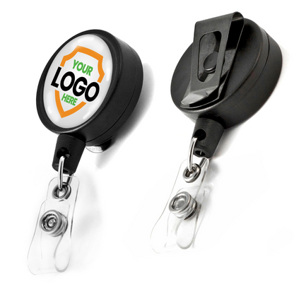 Two Customizable Key-Bak Mid Size ID Badge Reels with Steel Belt Clip (6ID) - Upload Your Logo. The front of one badge reel offers logo customization, labeled "Your Logo Here," to enhance brand awareness. Clear plastic clips are attached to both custom badge reels.