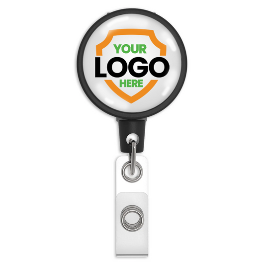 A Customizable Key-Bak Mid Size ID Badge Reel with Steel Belt Clip (6ID) - Upload Your Logo with customizable text reading "Your Logo Here" on a white background featuring an orange and green shield design. Enhance brand awareness with this badge holder, which includes a convenient clip at the bottom.