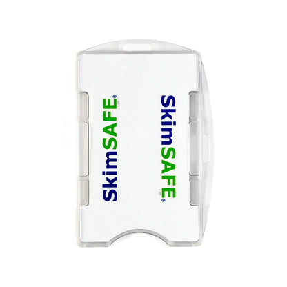 A white SkimSAFE RFID Blocking 2-Card ID Holder (AH-210 / 153039) with a transparent edge, shown from above with the brand name printed in blue and green letters. This slim holder provides reliable protection against RFID skimming while keeping your essential cards organized and secure.