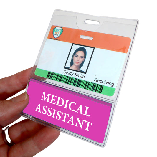 A hand holds a role-identifying badge for "Cindy Smith" labeled "Receiving," with a pink MEDICAL ASSISTANT Badge Buddy prominently displayed below, highlighting her position. Sold by Specialist ID.