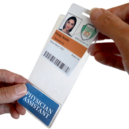 A hand holds a badge labeled "Operations Specialist" with a woman's photo and ID details, inserting it into the PHYSICIAN ASSISTANT BadgeBottom Holder & Badge Buddy IN ONE!! This vertical sleeve efficiently manages role identification alongside the Physician Assistant Badge.