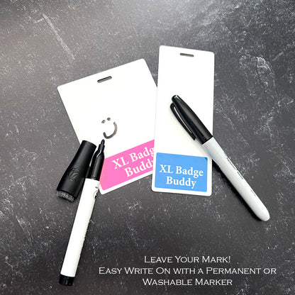 Two Extra Large Patient Support Badge Buddy cards rest on a dark surface with permanent markers nearby. The text reads, "Leave Your Mark! Ideal for healthcare settings, these XL Badge Backer for Patient Support cards are easy to write on with either a permanent or washable marker, making them perfect for patient support.