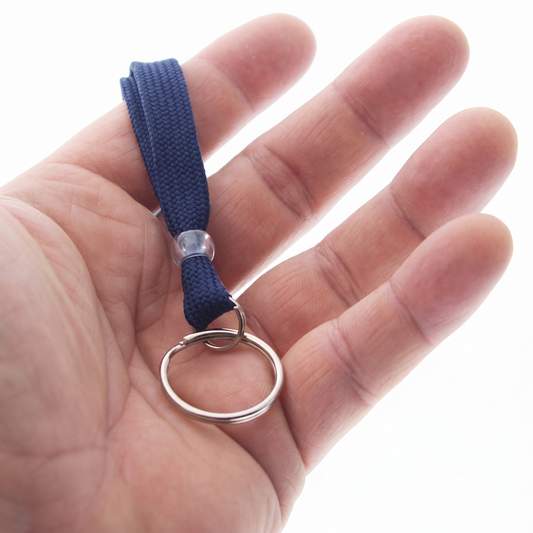 A hand holding the navy blue Premium Key Ring Lanyard with Breakaway Clasp (BL-34R), featuring a blue 3/8 inch wide fabric strap with a split ring keychain, against a white background.