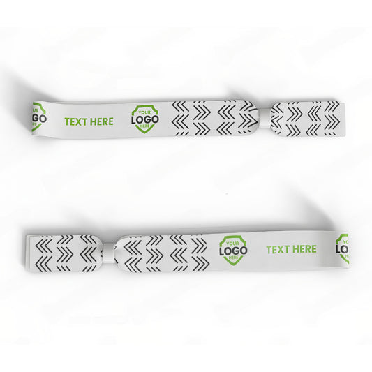 Two white lanyards with black arrow patterns and green areas labeled "TEXT HERE" and "YOUR LOGO" on a white background—ideal for pairing with a Custom Printed Wristband at any event.