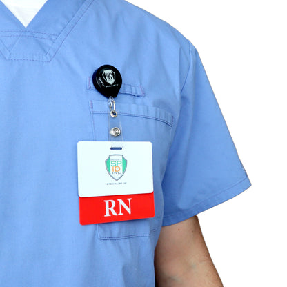 Person in light blue scrubs with a Custom Printed Clear Badge Buddy Horizontal (Standard Size) - Customize with Title and Color that reads "RN" and features a logo, clipped to their chest pocket.