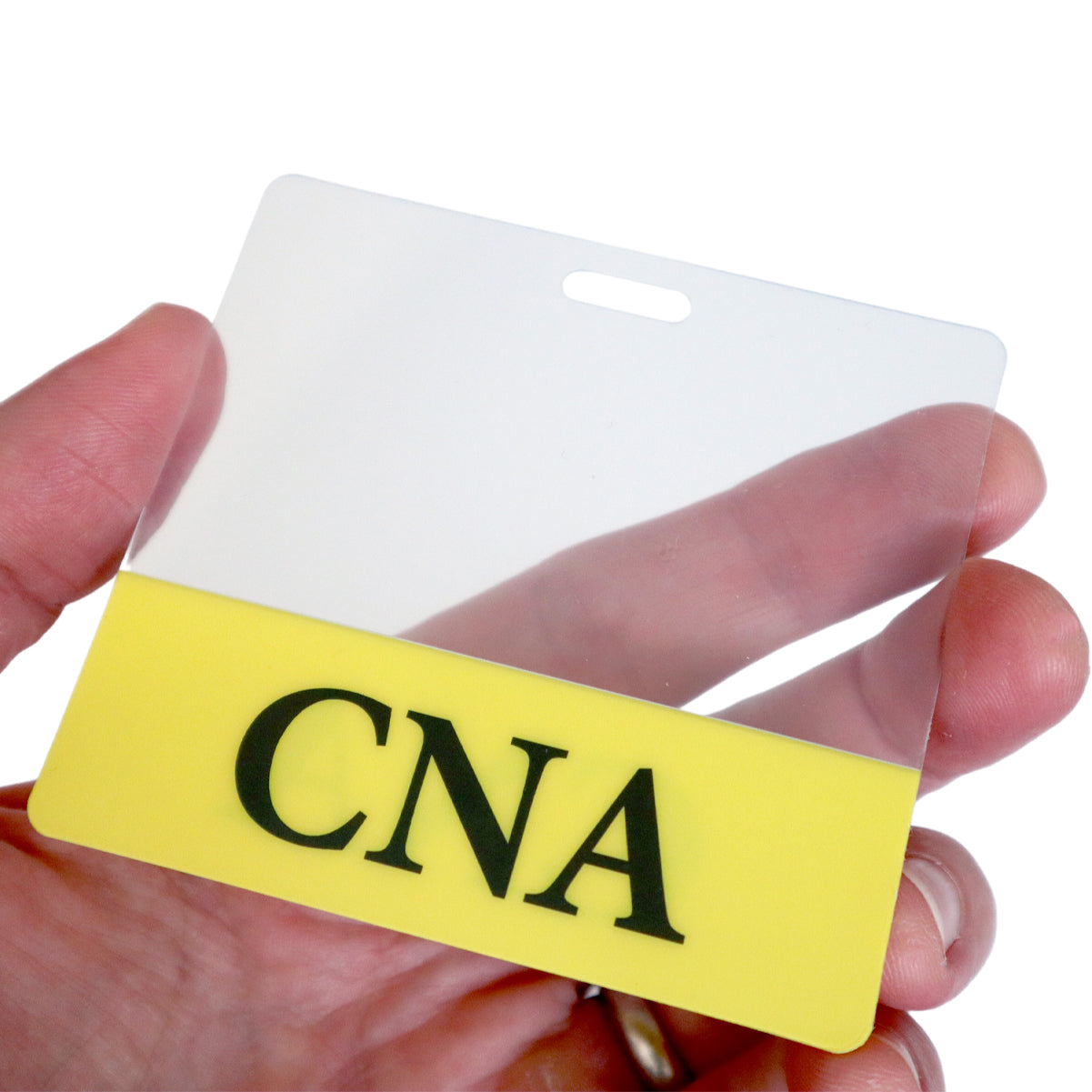 A hand holds a Custom Printed Clear Badge Buddies Horizontal (Standard Size) - Customize with Title and Color with a yellow section at the bottom displaying the letters "CNA" in black text, crafted by Specialist ID.