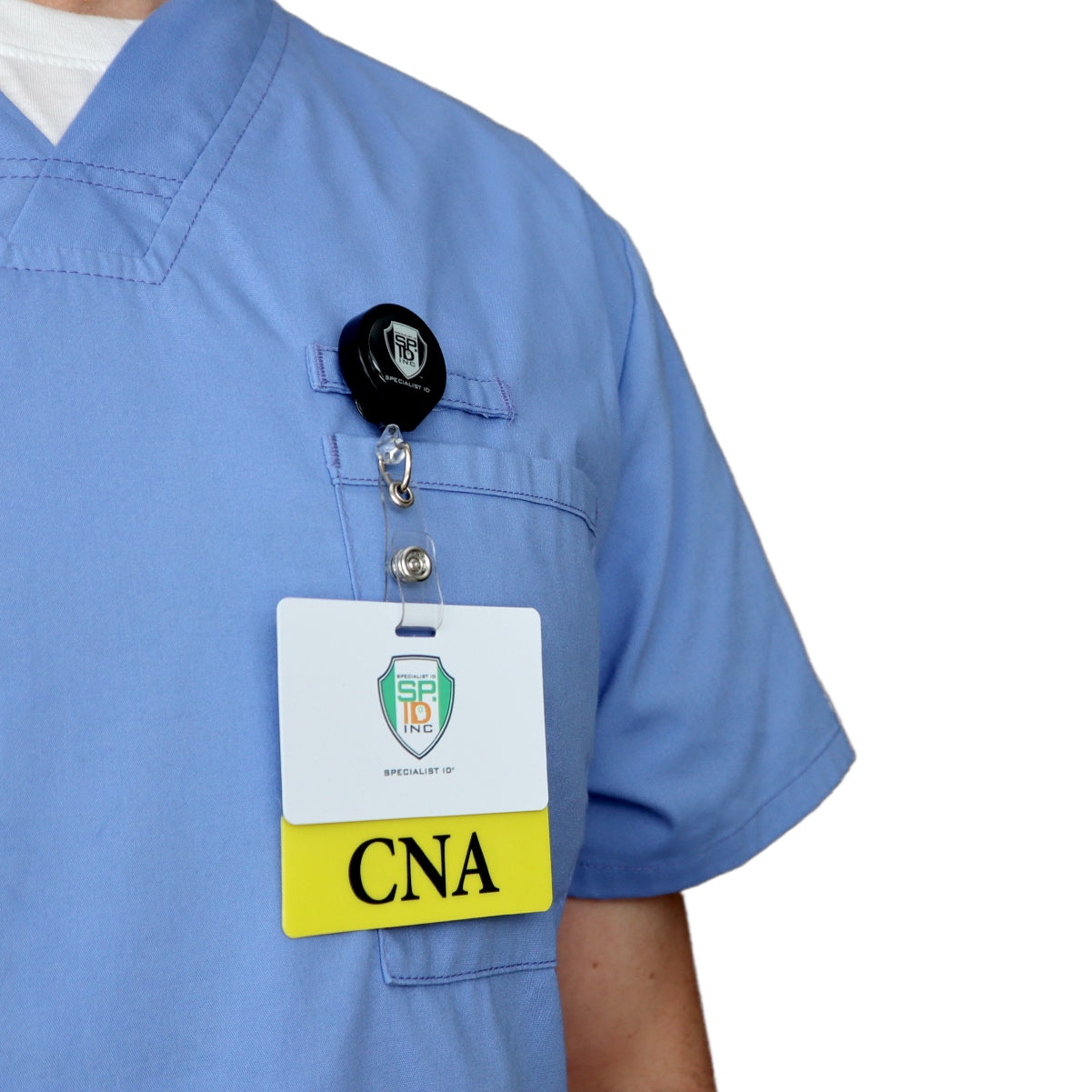 Close-up of a person wearing blue scrubs with a badge holder showing a white card labeled "SP-10 INC" and a yellow card labeled "CNA," utilizing a Clear CNA Badge Buddy - Horizontal ID Badge Backer for Nursing Assistant - Double Sided Print for clear visibility.