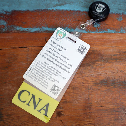 Close-up of a Clear CNA Badge Buddy Vertical with Yellow Border for Nursing Assistants on a retractable reel attached to a Vertical ID Badge Backer outlining workplace values and guidelines, placed on a wooden surface.