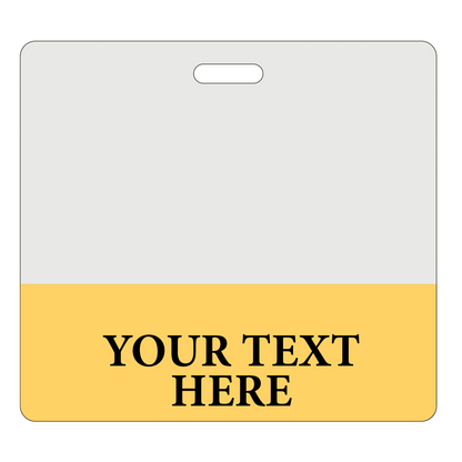 A two-tone badge with a grey top half and a yellow bottom half. The bottom half contains the text "YOUR TEXT HERE" in bold, black letters, perfect for creating Custom Printed Clear Badge Buddies Horizontal (Standard Size) - Customize with Title and Color from Specialist ID.