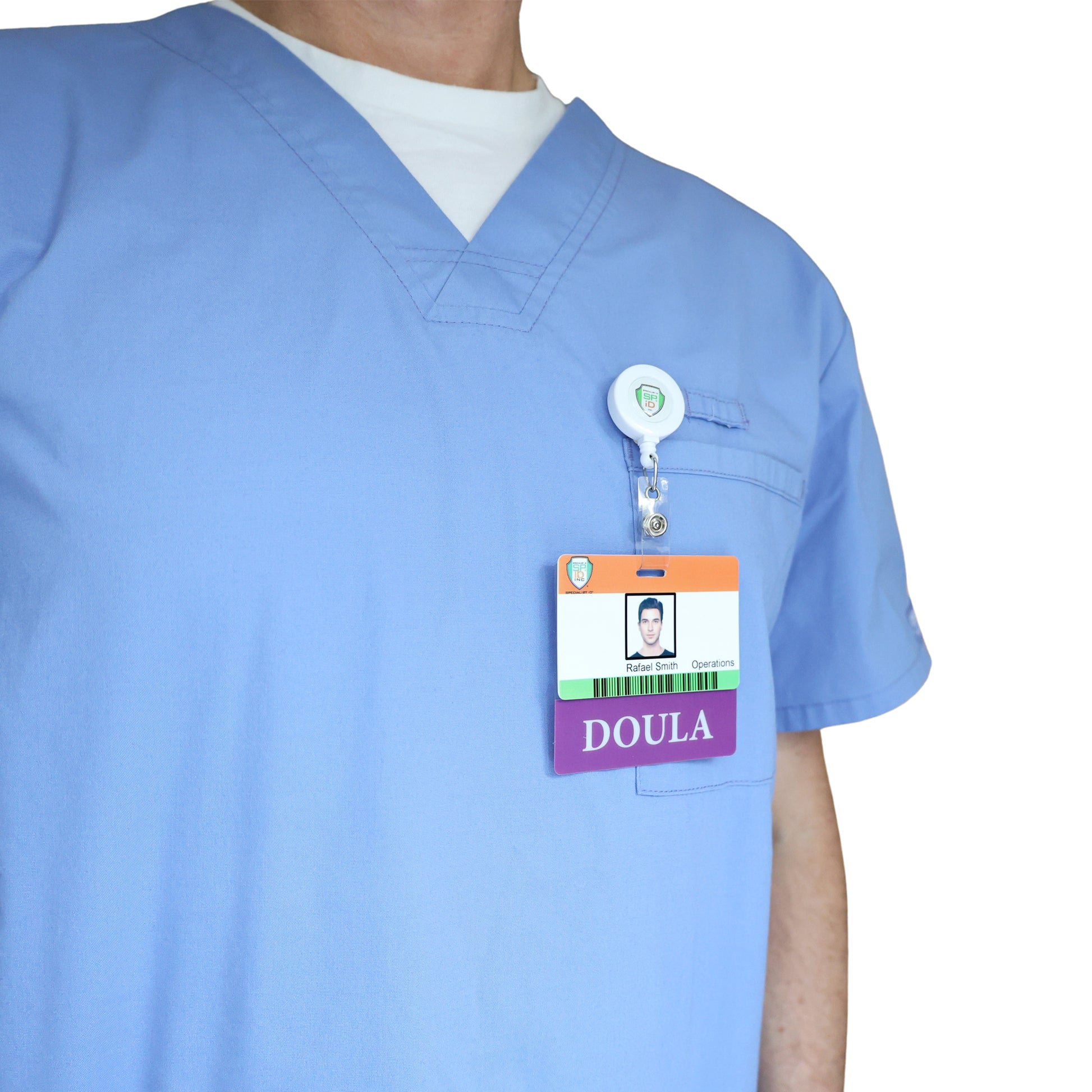 Person wearing light blue scrubs with a Clear DOULA Badge Buddy—Horizontal Nurse ID Badge Backer, double-sided print—clipped to the chest pocket for a professional doula look against a plain white background.