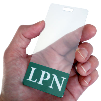 A hand holds a Custom Printed Clear Badge Buddies Vertical (Standard Size) - Customize with Title and Color with "LPN" in white on a green background, ensuring instant role recognition.