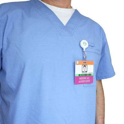 A person in light blue scrubs wears a Clear MEDICAL ASSISTANT Badge Buddy—Horizontal Nurse ID Badge Backer, double sided print—clipped to the chest, enhancing role recognition. Sold by Specialist ID.