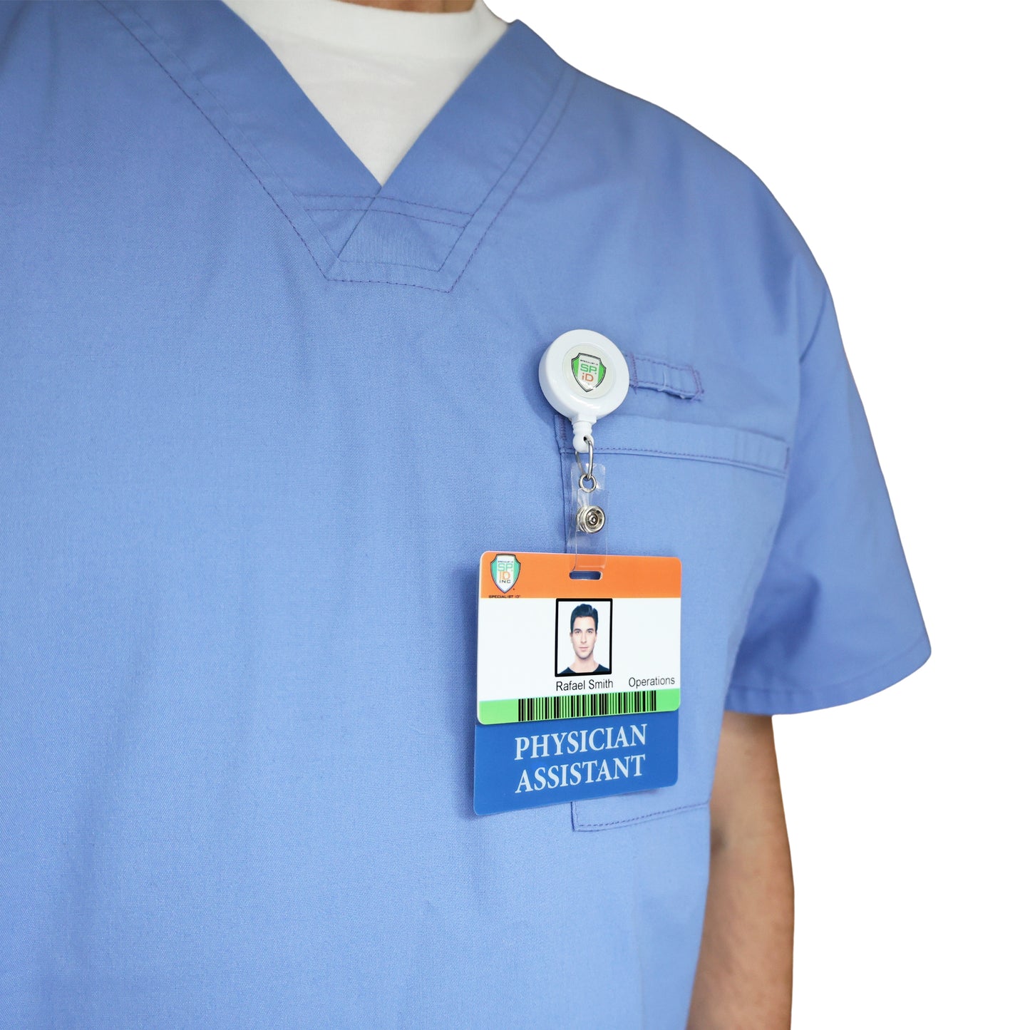 A person in blue scrubs with a white undershirt has the Clear PHYSICIAN ASSISTANT Badge Buddy—Horizontal Nurse ID Badge Backer, double-sided print—clipped to their chest pocket for clear role recognition.