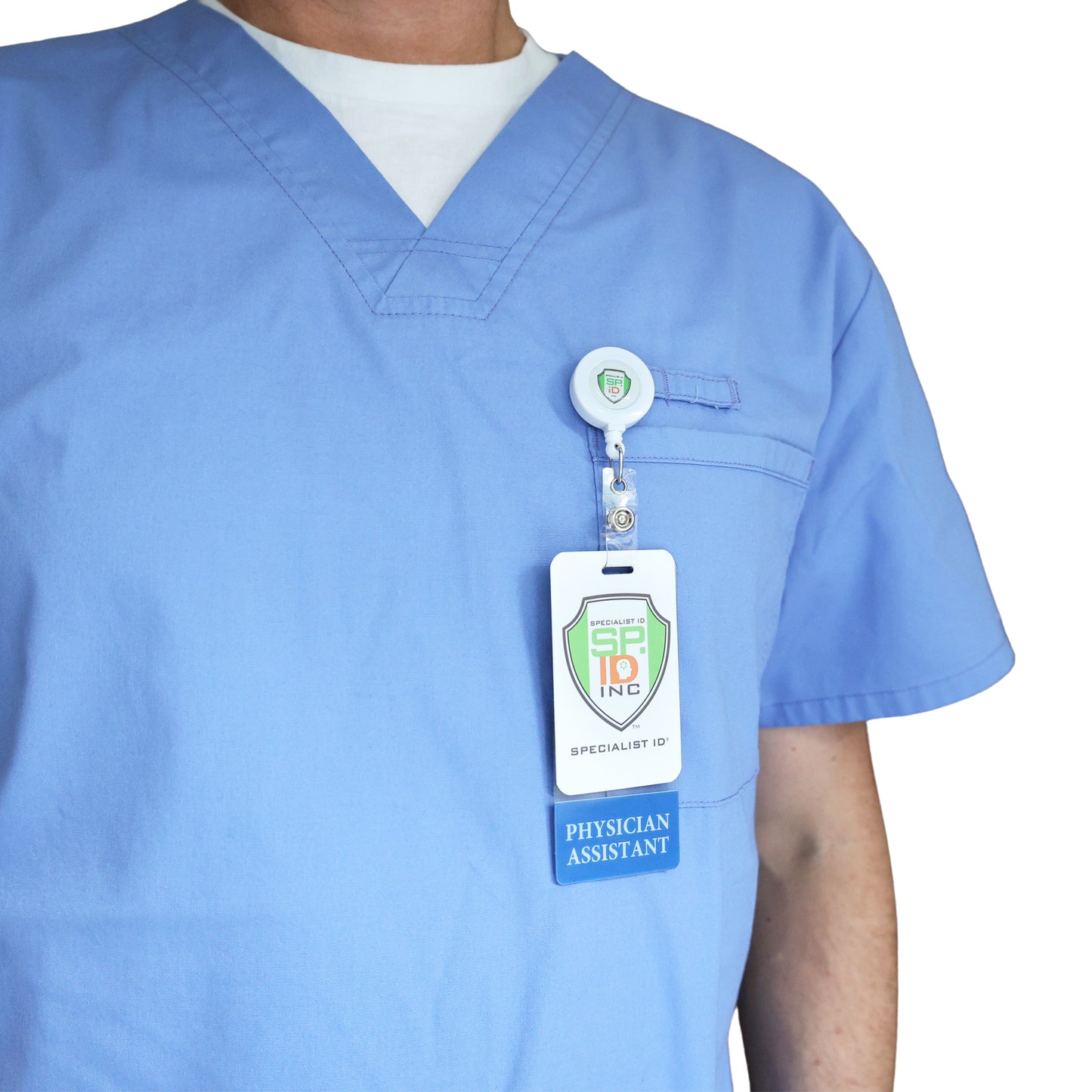 A person wearing light blue scrubs with a Clear PHYSICIAN ASSISTANT Badge Buddy Vertical with Blue Border for Physician Assistants clipped to their chest pocket, clearly identifying them as a Physician Assistant.