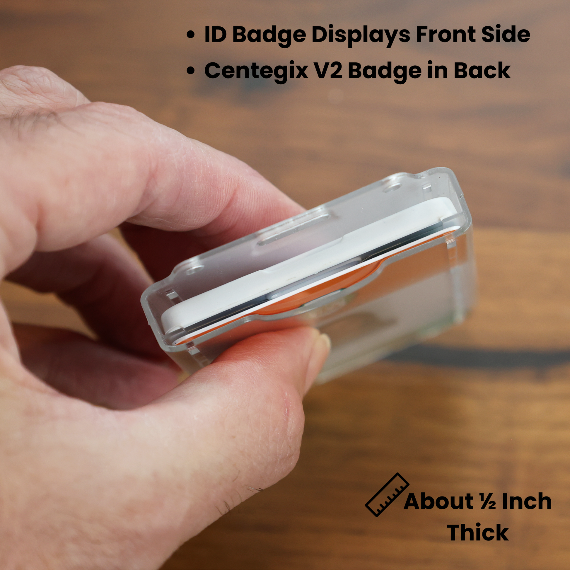 A hand holds the Dual Badge Holder Compatible with Centegix™ V2 Alarm Card + Standard ID Card, showing its approx. 1/2-inch thickness. The Specialist ID Inc. logo is visible in the upper right corner.