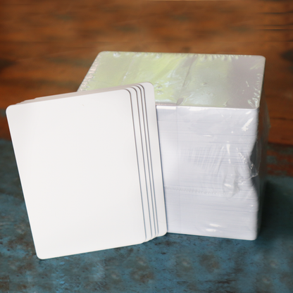 Blank white composite PVC/PET cards on wood surface