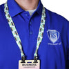 Person wearing a blue polo with a Specialist ID logo and a conference badge on our Custom Double Ended Lanyards—personalized lanyards with 2 clips for event ID badges, customized with your logo, text, or artwork, showcasing our printing quality.