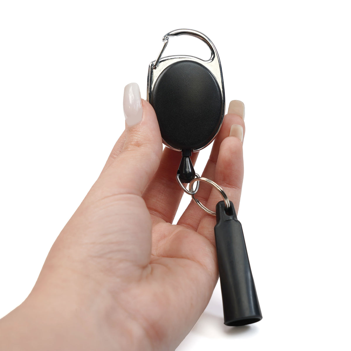 A hand holds the Retractable Pen & Pencil Holder Badge Reel with Carabiner Clip (SPID-3280), a black retractable keychain featuring a metal clip and cylindrical plastic attachment, designed to securely and conveniently keep your pens and pencils accessible.