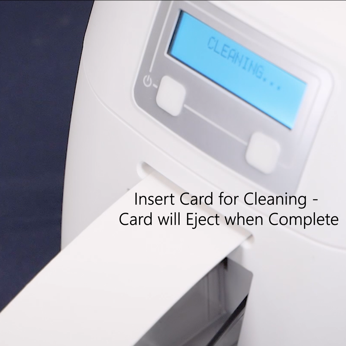 Cleaning card in action with digital display of the ID badge printer and text indicating card insertion for cleaning.