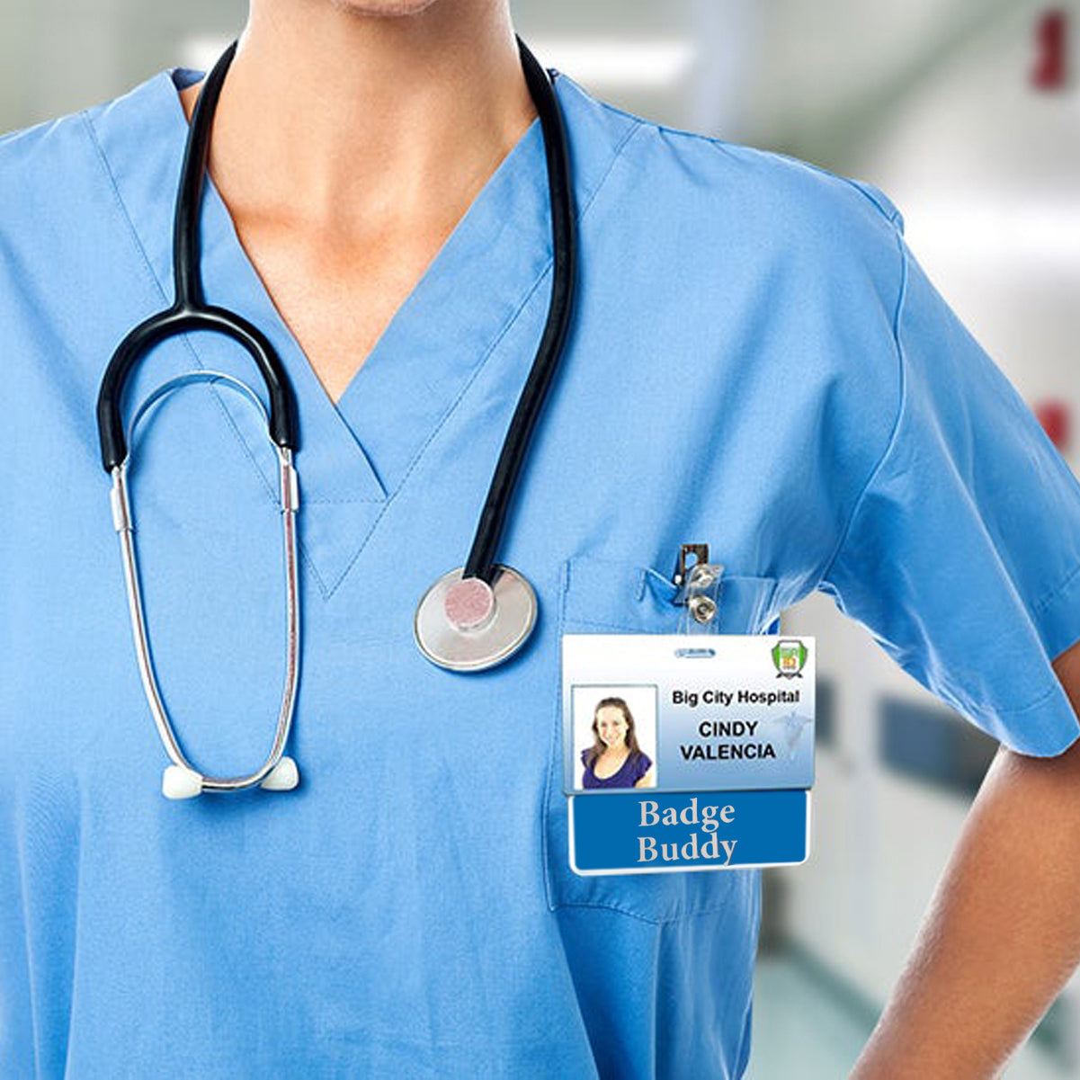 A medical professional in blue scrubs with a stethoscope and hospital ID wears a CNA Badge Buddy - Horizontal Hospital ID Role Identifier (Black Border, White Text), standing confidently in a hospital.