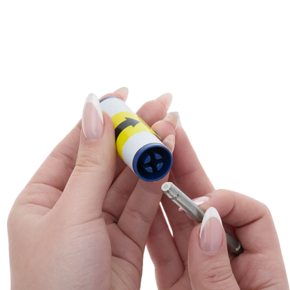 A person holds a Magicard 3633-0054 Cleaning Roller Kit tube, featuring yellow and blue colors and an arrow, and inserts a metal tool with a white tip into one end of the tube to prepare adhesive cleaning rollers for use with the Magicard 300 and 600 ID Card Printers (5 Pack).
