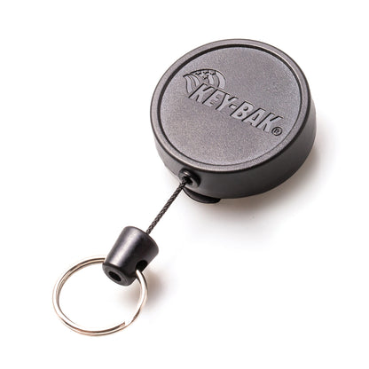 A round, black Key-Bak Mid Size Key Ring Badge Reel with Belt Clip (#6), branded with "KEY-BAK" on the surface. It features a convenient belt clip for easy access and security.