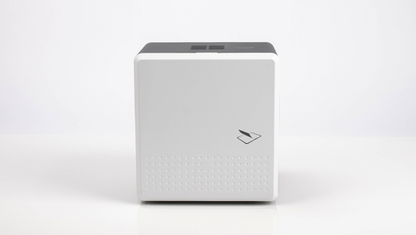 A white, cube-shaped electronic device, the IDP SMART-81L Laminator Option for SMART-81 Printers (P/N 653635), with a small symbol on the front, sits against a light background.