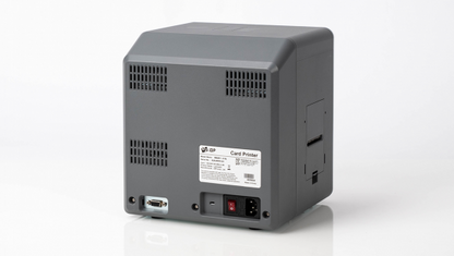 Rear view of the IDP SMART-81L Laminator Option for SMART-81 Printers (P/N 653635) with multiple ventilation grilles, a power socket, a USB port, and a label with specifications for added tamper-resistance.