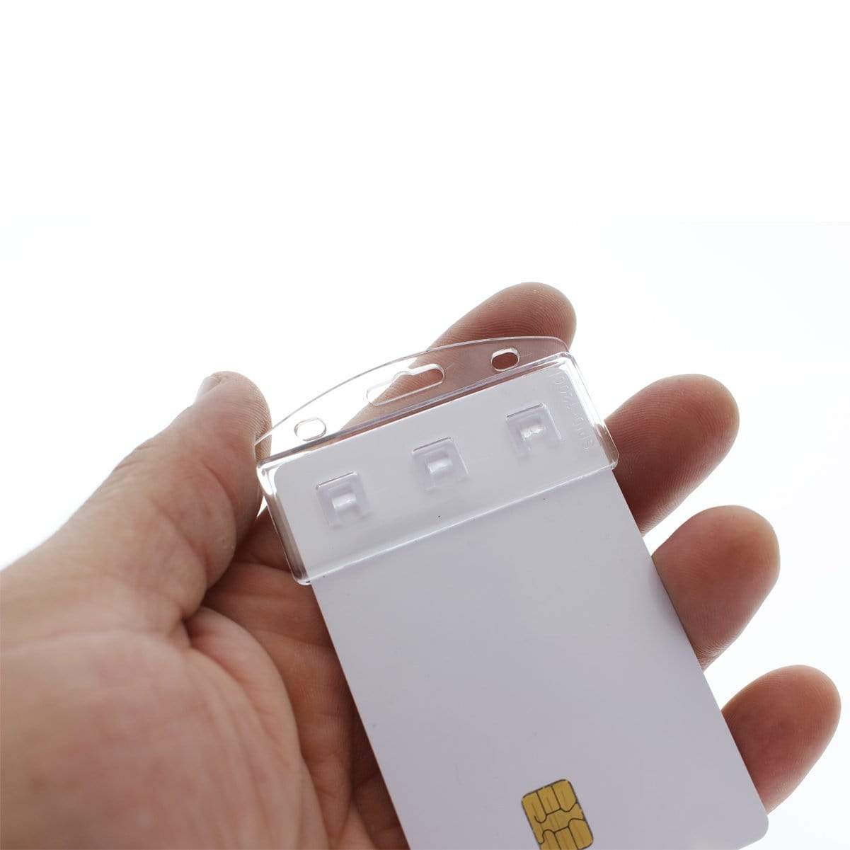 A hand holding a blank white card with a SIM card and three detachable plastic pieces in a transparent package at the top, ideal for Custom Vertical Half Card Badge Holder for Smart Chip (SPID-1200) - Add Your Logo and corporate branding accessories.