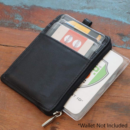 Black zippered cardholder with various cards inside, including a Clear Vinyl Business Card Holder - Medicare Card Protective Sleeve (1840-3505), displayed on a wooden surface. Text at the bottom states, "*Wallet Not Included.