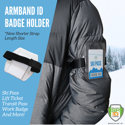 A person wears a "SPID-1710" jacket with a rugged vinyl, transparent armband ID badge holder labeled "SKI PASS." The features include vertical armband holders ideal for ski passes, lift tickets, work badges, and more. It offers an adjustable hook and loop strap for convenience.