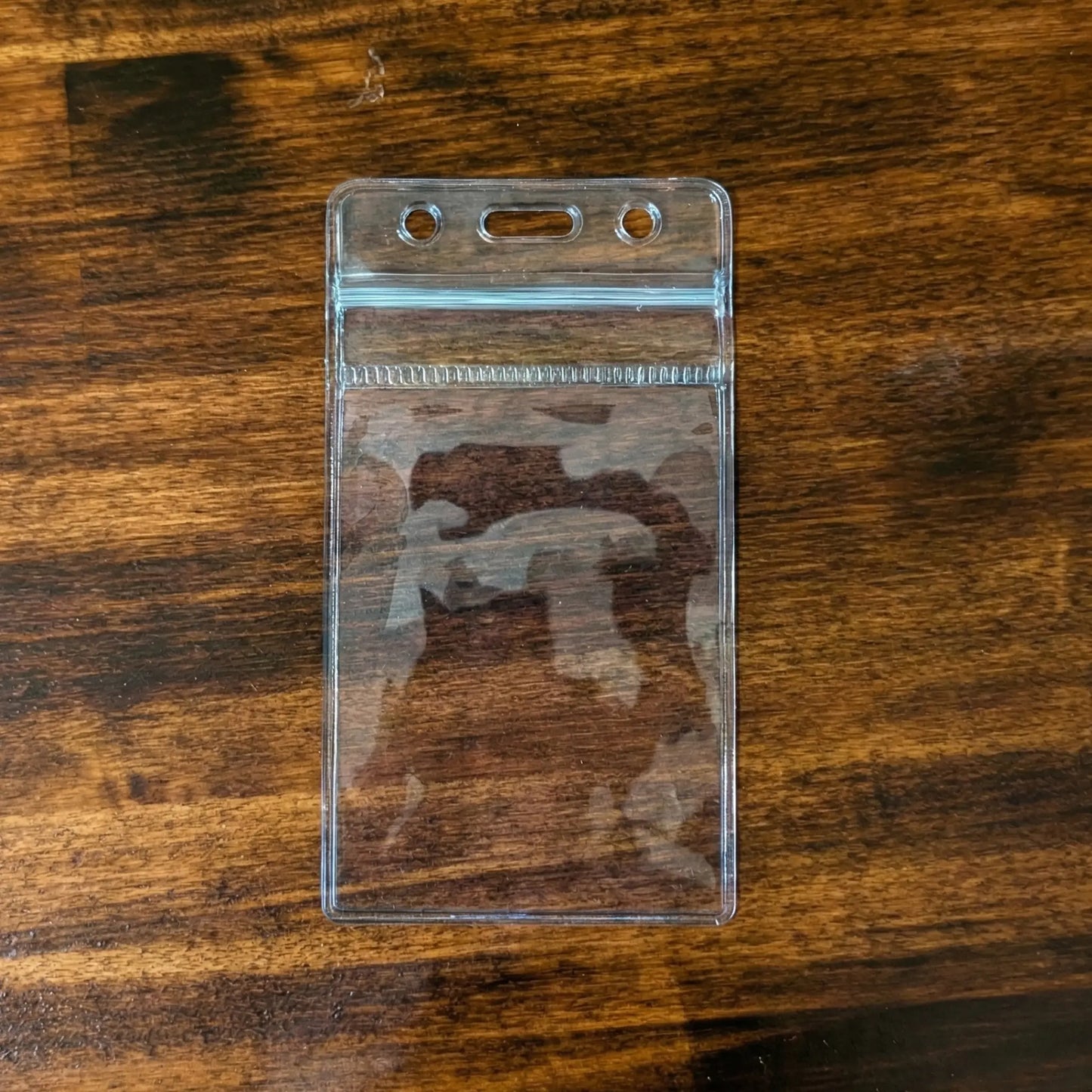 SPID-1740 clear vinyl vertical badge holder with zipper closure on wood surface