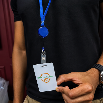 A person in a black shirt holds a blank badge on a Breakaway Badge Lanyard with Retractable Reel (SPID-210X), displaying the "Specialist ID" logo on the card.