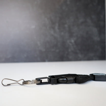 A Heavy Duty Breakaway Lanyard for ID Badges & Keys (SPID-2460), featuring a metal clip and detachable key ring, lies on a white surface. Sold by Specialist ID.