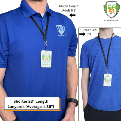 Two people in blue shirts display the Short Breakaway Lanyard with Metal Swivel Hook (SPID-2470), sized for students and smaller frames. The black 28" lanyard features a safety breakaway clasp and is modeled by an adult (6'1") and a 13-year-old (5'3").