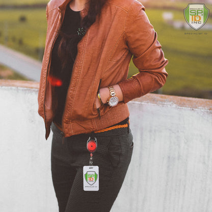 Person wearing a brown leather jacket and dark pants, displaying an ID badge attached to a Carabiner Badge Reel - Premium Retractable Oval Badge Holder with Carabiner Clip for Belt Loops & Purse Straps (2120-70XX) from Specialist ID Inc.