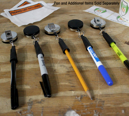 Five writing instruments attached to Heavy Duty Retractable Pull Pen & Pencil Holder Reel SPID-3240 are lined up on a wooden surface. The instruments include a pencil, a highlighter, and three markers. Additional items are in the background.