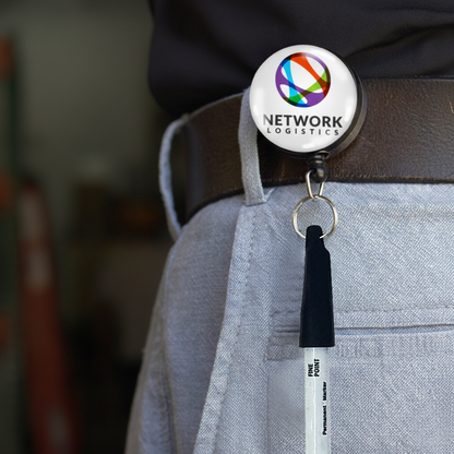 Close-up of a Custom Pen Reel with belt clip, featuring your logo, securely holding a pen. This heavy-duty custom printed pen reel attaches easily to your belt loop. Sold by Specialist ID.