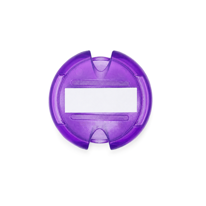 The Stethoscope ID Tag Covers with Writable Surface (SPID-3820) is a round, purple plastic tag featuring two notches on opposite sides and a rectangular white write-on label in the center, shown from above on a white background.