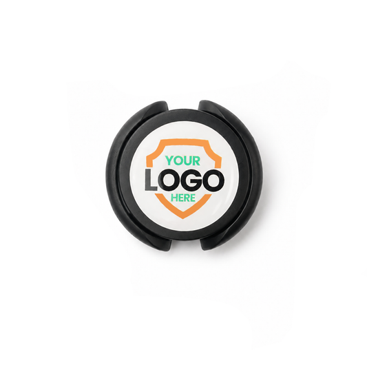 A Custom Stethoscope ID Tag featuring a black circular design with "YOUR LOGO HERE" is displayed before an orange shield on a white background, ideal for medical staff identification.