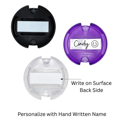 Stethoscope ID Tags—black, purple, and clear—with writable surfaces for easy name labeling on back side; the purple tag is shown with a sample handwritten name. Perfect for quick staff identification.