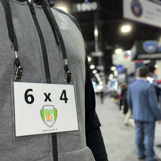 Black double clip lanyard holding a 6 x 4 event badge