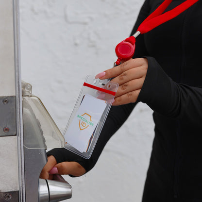 A person holds a red Cruisin Through Life™ Retractable Badge Reel Lanyard with Resealable Zip Holder (SPID-9101) with a clear, resealable zip holder near a door handle.