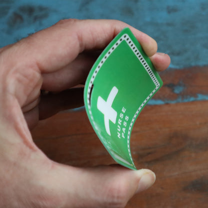 A hand holding a waterproof laminated green card labeled "School Hall Pass Lanyards WITH UNBREAKABLE CARD PASSES (SPID-9800)," commonly used for school hall passes.