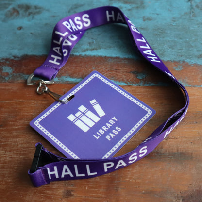A School Hall Pass Lanyards WITH UNBREAKABLE CARD PASSES (SPID-9800) placed on a wooden surface.