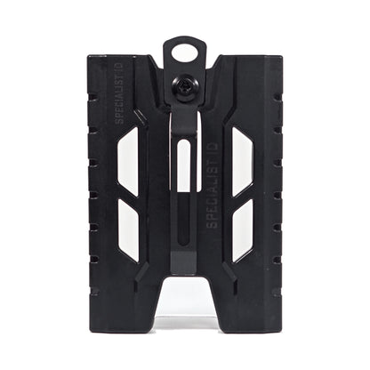 Back view of the black TEST-123 rigid vertical ID badge holder, showing the metal spring belt clip down the center, the thumb cutouts and the Specialist ID name molded into the side rails.