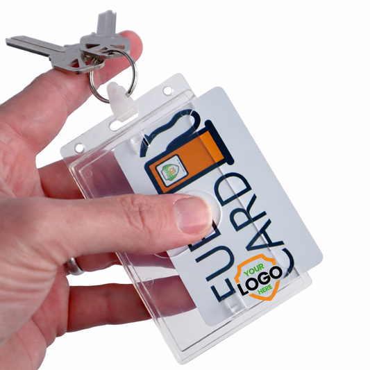 Hand holding a fuel card keyring holder with a Your Logo Here shield printed near the bottom, overlapping the inserted card.
